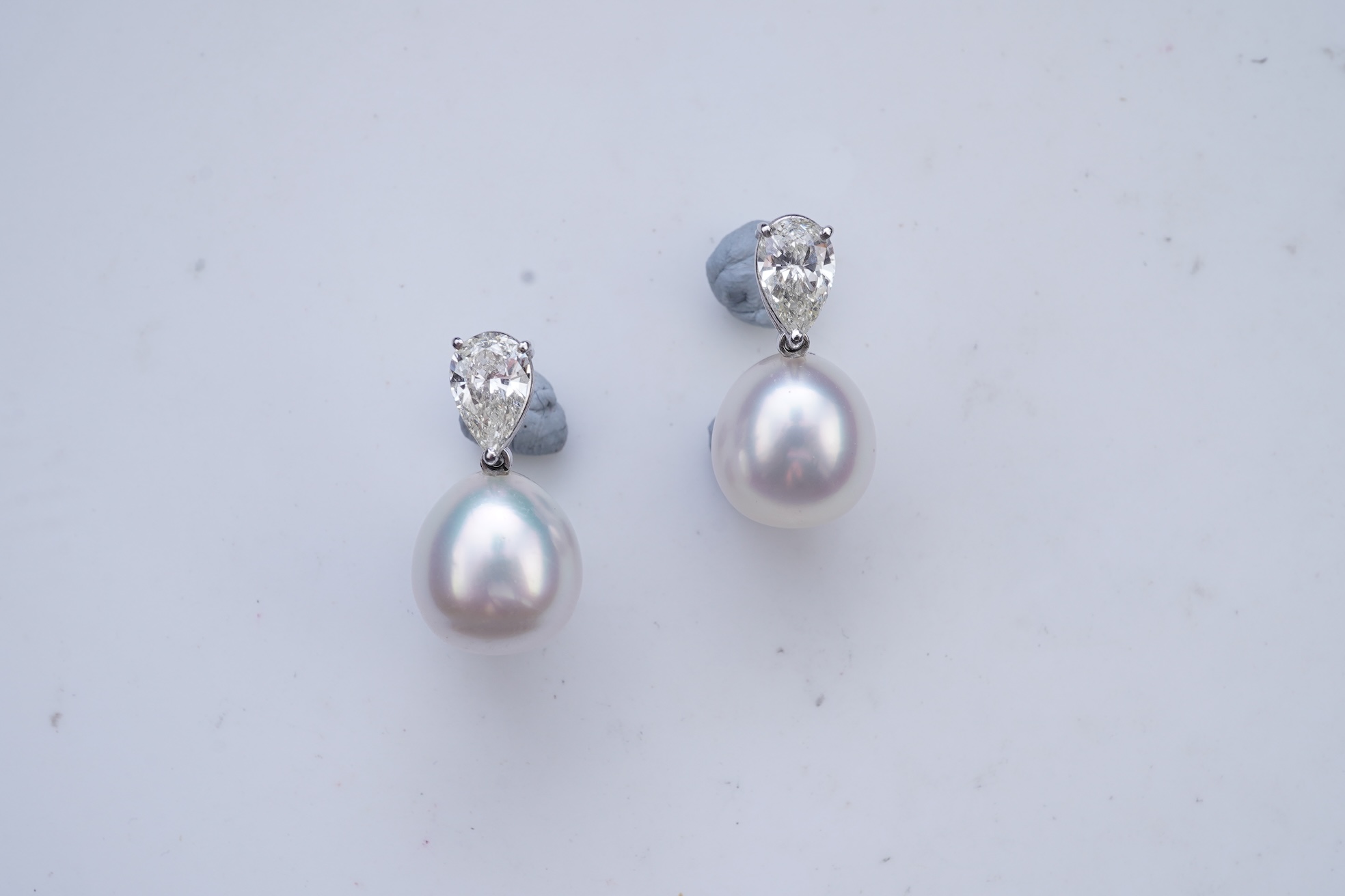 A pair of cultured pearl and diamond earrings